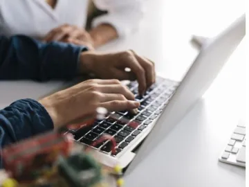 person typing on a laptop 